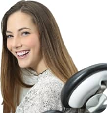 smiling woman sitting on a dental chair